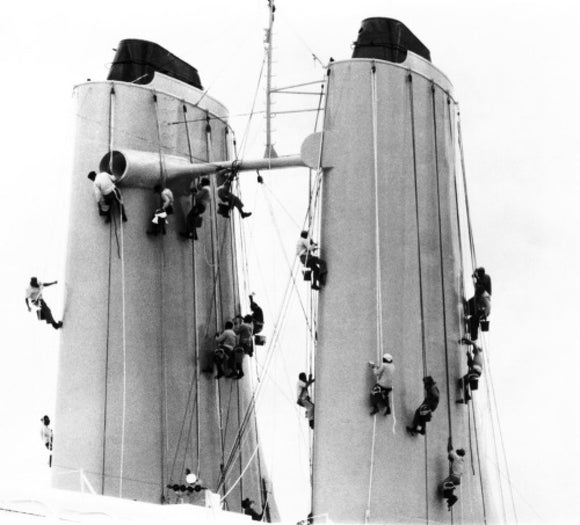 Crew members cleaning CANBERRA's funnels