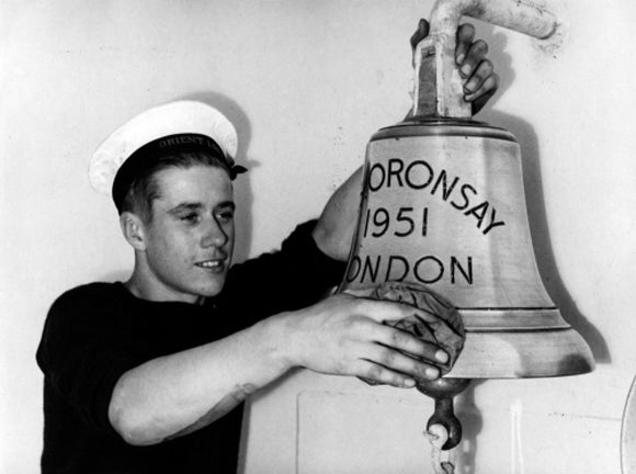 Cleaning the ship's bell on board ORONSAY